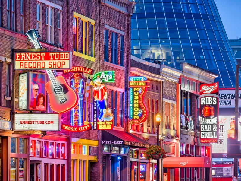 Neon signs on Lower Broadway in Nashville at dusk