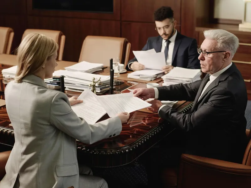 Attorneys reviewing documents at a conference table